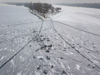 Aerial drone top view. Frosty pattern drawing on the river. Cloudy frosty winter morning.
