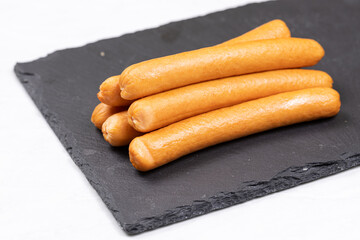 Cooked Hot Dogs served on the plate with white background