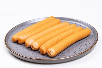 Cooked Hot Dogs served on the plate with white background