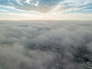 Fog over the snowy Kiev city. Aerial drone view. Foggy winter day.