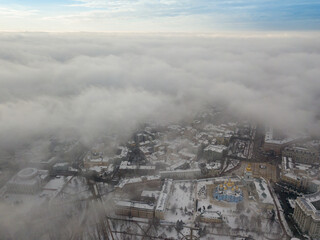 Obraz premium Fog over the snow-covered St. Michael's Cathedral in Kiev. Aerial drone view. Foggy winter day.