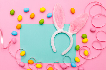 Easter bunny. Happy Easter holiday background concept.Flat lay colorful bunny egg with accessory to celebration on modern rustic pink pastel paper at home office desk.