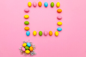 Easter bunny. Happy Easter holiday background concept.Flat lay colorful bunny egg with accessory to celebration on modern rustic pink pastel paper at home office desk.