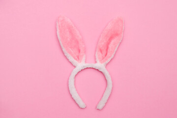 Easter bunny. Happy Easter holiday background concept.Flat lay colorful bunny egg with accessory to celebration on modern rustic pink pastel paper at home office desk.