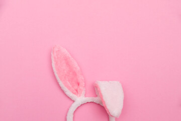 Easter bunny. Happy Easter holiday background concept.Flat lay colorful bunny egg with accessory to celebration on modern rustic pink pastel paper at home office desk.