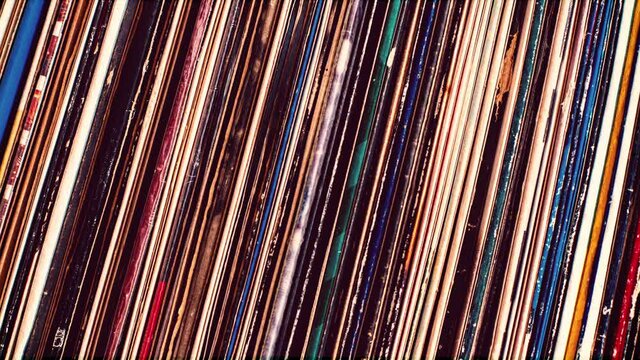 Vinyl large collection of records aligned on shelf close up vintage grunge scratched colorful burned film effect