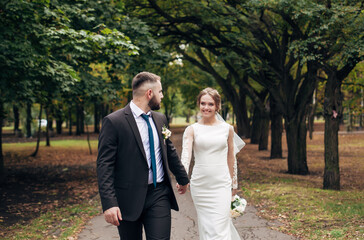 newlyweds walk in the autumn park
