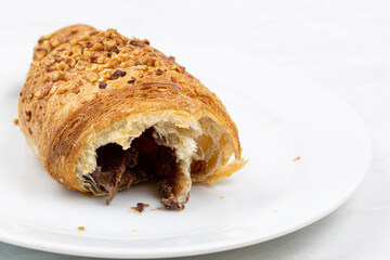 Croissant with chocolate on the plate