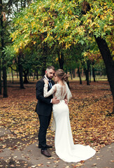 newlyweds walk in the autumn park