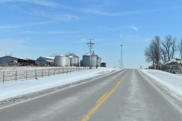 Grain Bins by a Rural Highway