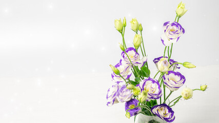 Blue and white lisianthus bouquet on the blurred background closeup. Nice greeting card for Mother's day, Women's day or Valentine's day. Banner photo with space for your greeting.