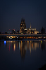 Cologne Cathedral by night, iluminated, reflection in the Rhine river