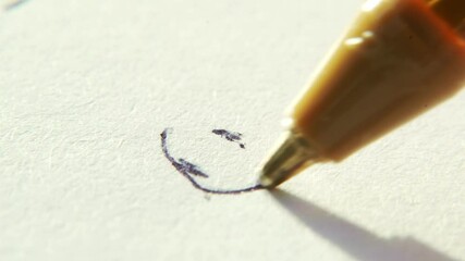 Close up of kid doodling on paper with a pen