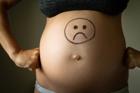 Sad angry pregnant woman. Weight gain and bad mood.