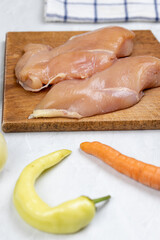 Raw Chicken white meat with vegetables on the table