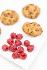 Crunchy biscuits with chocolate and fresh raw raspberries