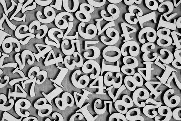 Wooden numbers from zero to nine on a gray background, abstract background.