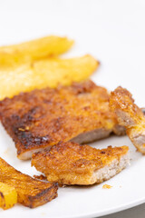 Fried Potatoes served with pork chops on the plate