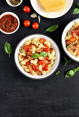 Pasta with bacon, tomato, parmesan cheese and basil leaves