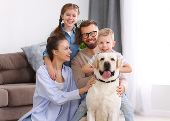 happy married couple playing with their favorite pet dog   at home