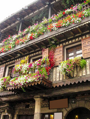 Typical houses of the medieval village of La Alberca with balconies full of flowers, province of Salamanca, Spain