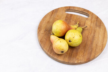 Fresh Pears on the wooden kitchen board