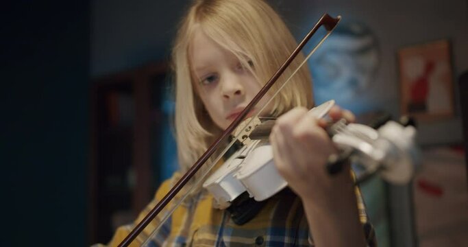 Home lesson boy kid playing the violin. Creative music activities for children during coronavirus covid 19 quarantine. Elementary school talented pupil learning and practice string music at home