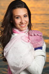 Beautiful young multicultural woman outdoors in a downtown urban setting by the bay with winter...