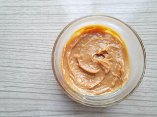 dulce de leche with coconut in glass jar with texture 