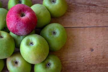 Apples stand on a wooden surface