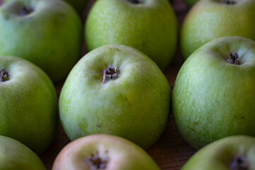 Apples stand on a wooden surface