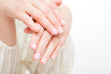 Fototapeta premium Womans hands with beautiful manicure on white background. Closeup shot of female hands with beautiful manicure