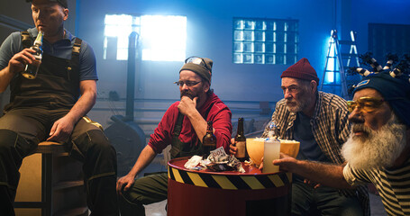 Mature man discussing match with friends in garage