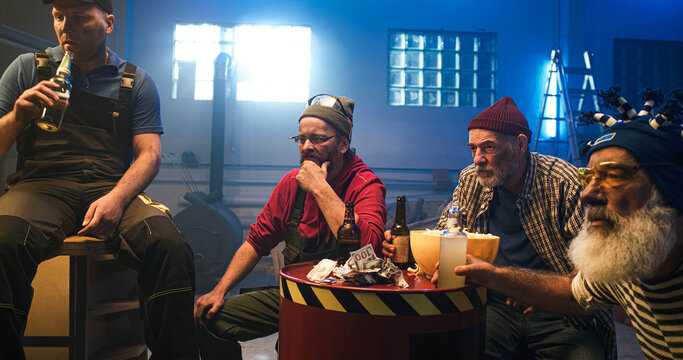 Mature man discussing match with friends in garage - Powered by Adobe