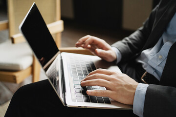 an economist in a business suit is sitting in the office. a lawyer in a business suit works on a laptop computer. prints the message 5G communication.