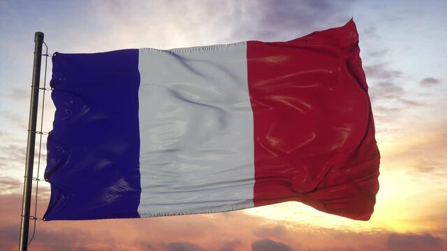 Flag of France waving in the wind against deep beautiful sky at sunset