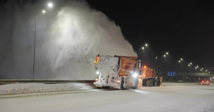  A grader clears snow on a road outside the city