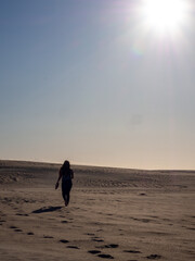 person walking on the beach