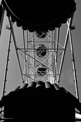 Black and white construction of the Ferris wheel from the inside. Industrial composition of metal architecture beauty. Abandoned damn wheel.