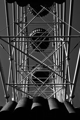 Black and white construction of the Ferris wheel from the inside. Industrial composition of metal architecture beauty. Abandoned damn wheel.
