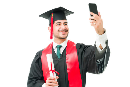 Male graduate posting a graduation photo on his social media