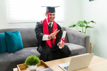 Latin man in his 20s in a video call for his virtual graduation