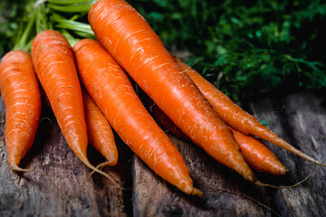 Fresh organic carrots on old wooden box. Organic food concept.