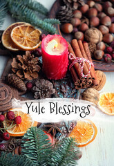 Yule Blessings. Winter altar for Yule sabbath. pagan holiday. Red candle, wheel of the year, cinnamon, nuts, cones, dry orange slices. Esoteric Ritual for Yuletide, Magical Winter Solstice