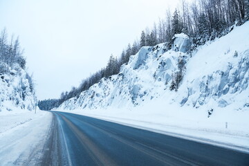 winter road between huge rocks 
