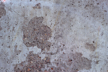 grey concrete wall with sctratched areas - textured background