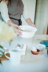 Young beautiful woman bakes a cake. Sweets. Confectionery.