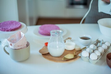 Young beautiful woman bakes a cake. Sweets. Confectionery.