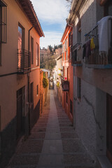 Quiet and quaint narrow streets in old town (Albaicin or Arab Quarter) Granada, Spain, Andalusia with views towards the Alhambra.