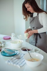 Young beautiful woman bakes a cake. Sweets. Confectionery.